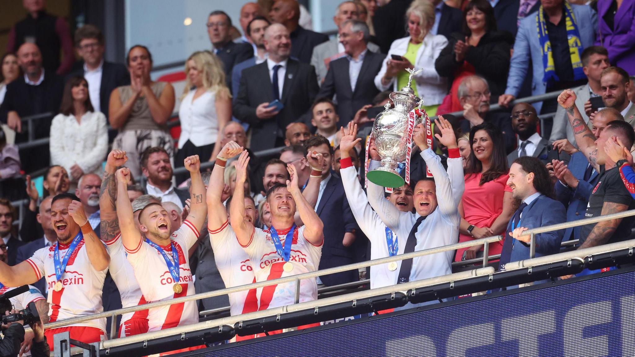 Hull KR boss Willie Peters lifts the Challenge Cup trophy