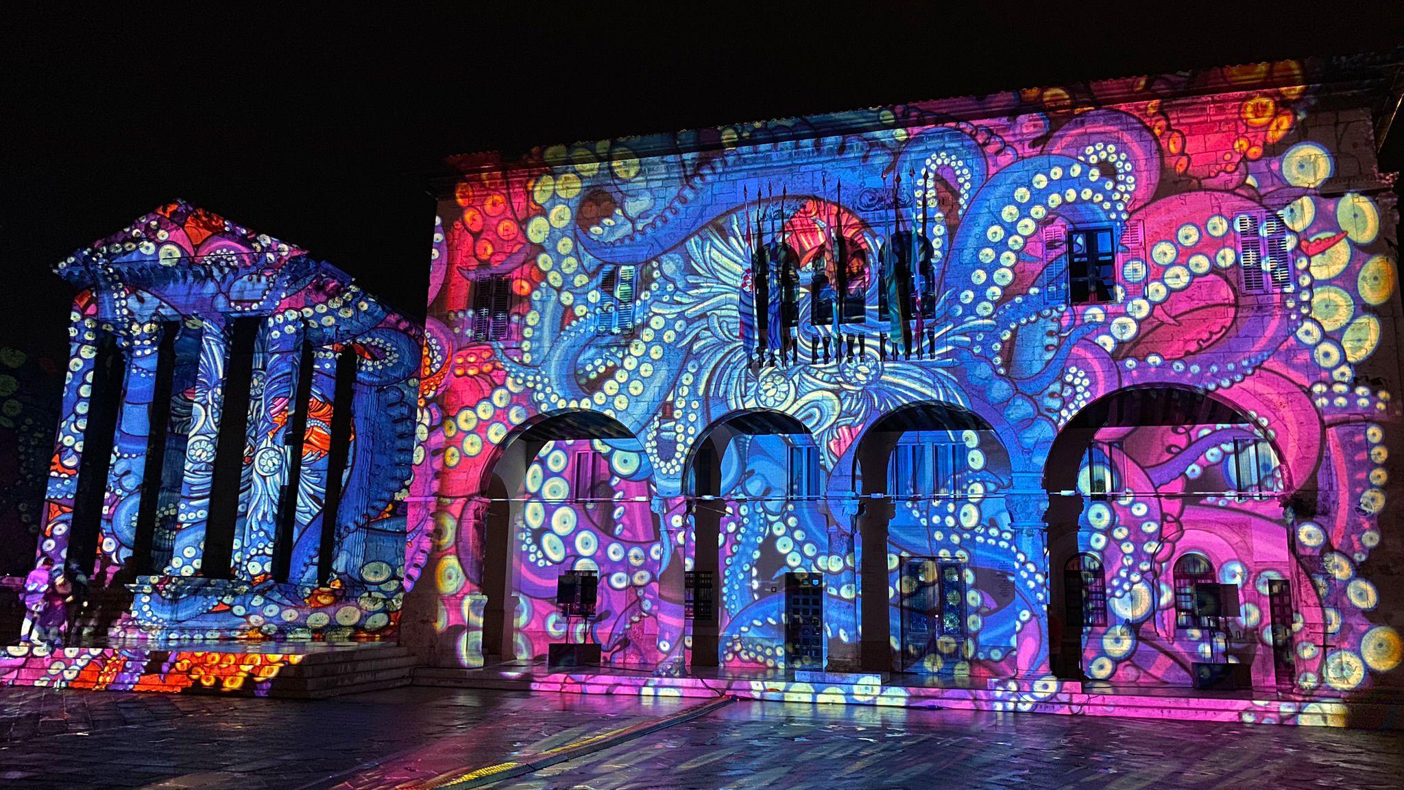 Synaptic Lights by Lightspray Visual - a flowing stream of light and colour on an building.