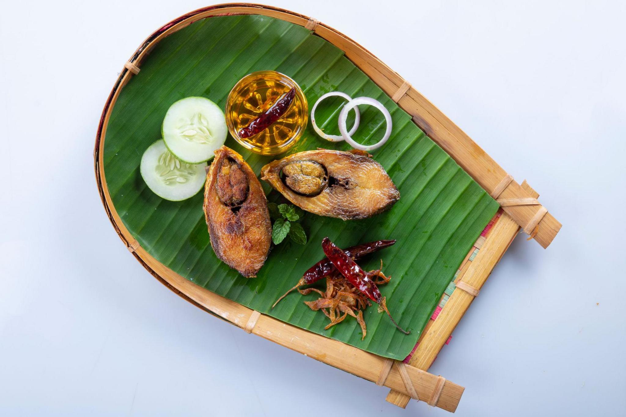 Ilish bhaji for Panta ilish, Bengali new year festive dish. Fried Hilsha slices with chilli, tomato and onion. Hilsa fry is popular in pohela boishakh. on kula.