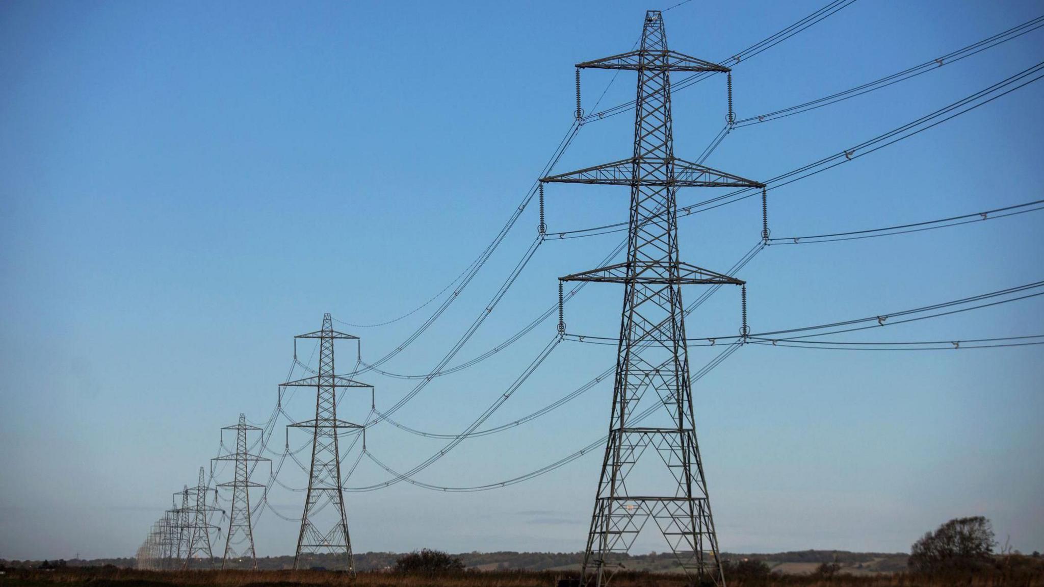 A row of pylons in a countryside