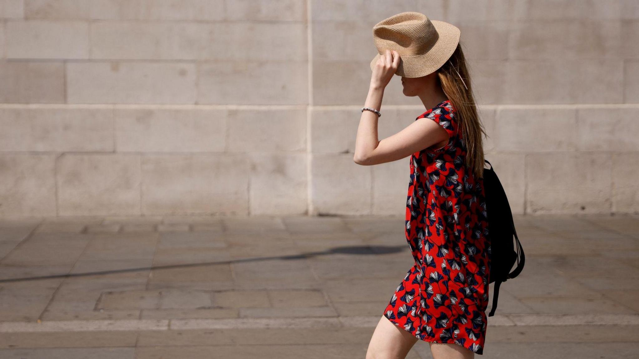 A woman shielding herself from the sun