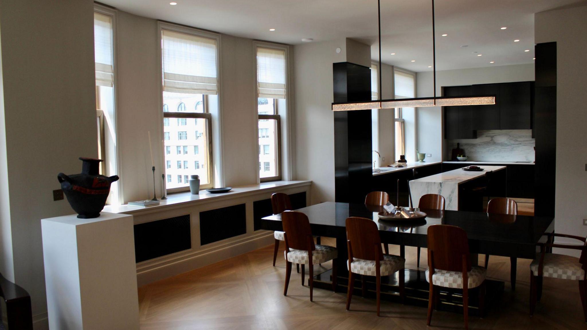 view of open-concept kitchen and modern dining furniture in residential unit, with large windows