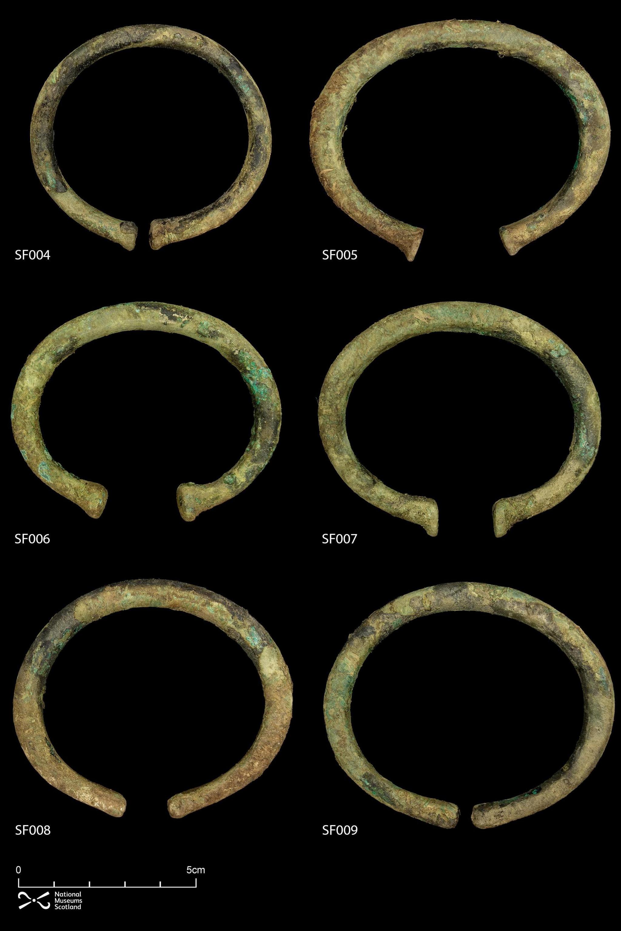 The bronze bracelets are laid out 
