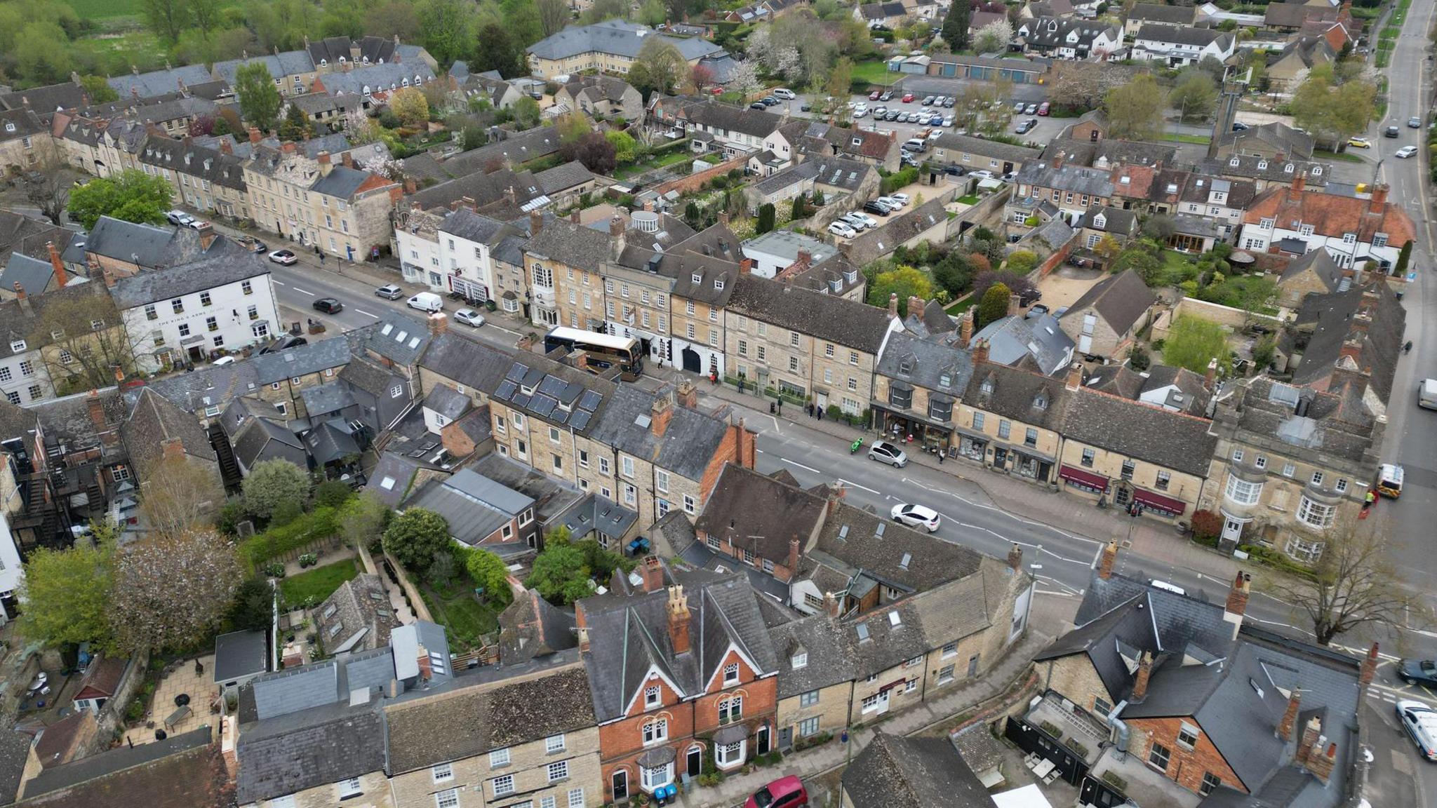 An aerial photo of residential roads in Woodstock, Oxfordshire. Most houses are terraced and beige in colour.