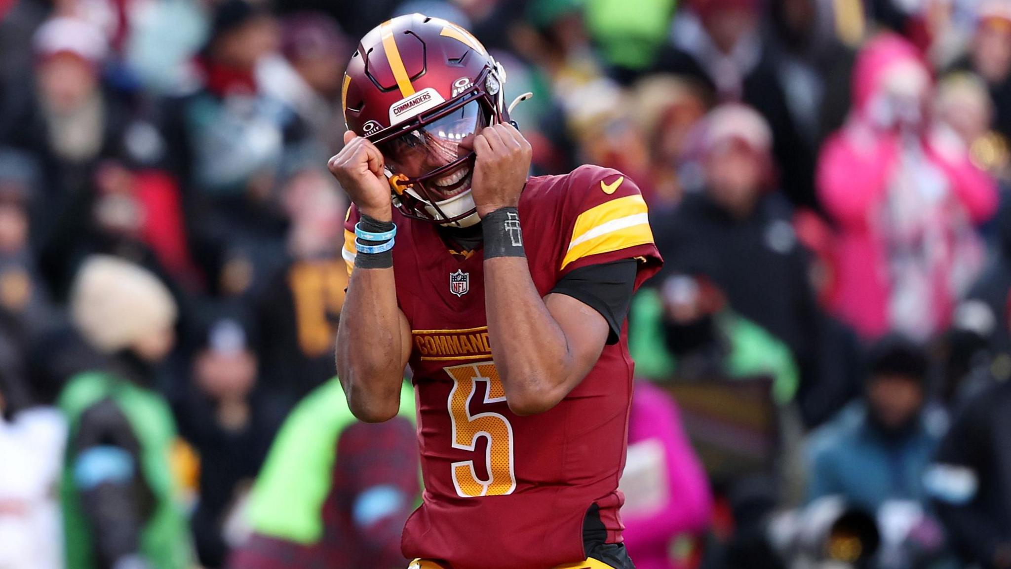 Washington quarterback Jayden Daniels celebrates victory