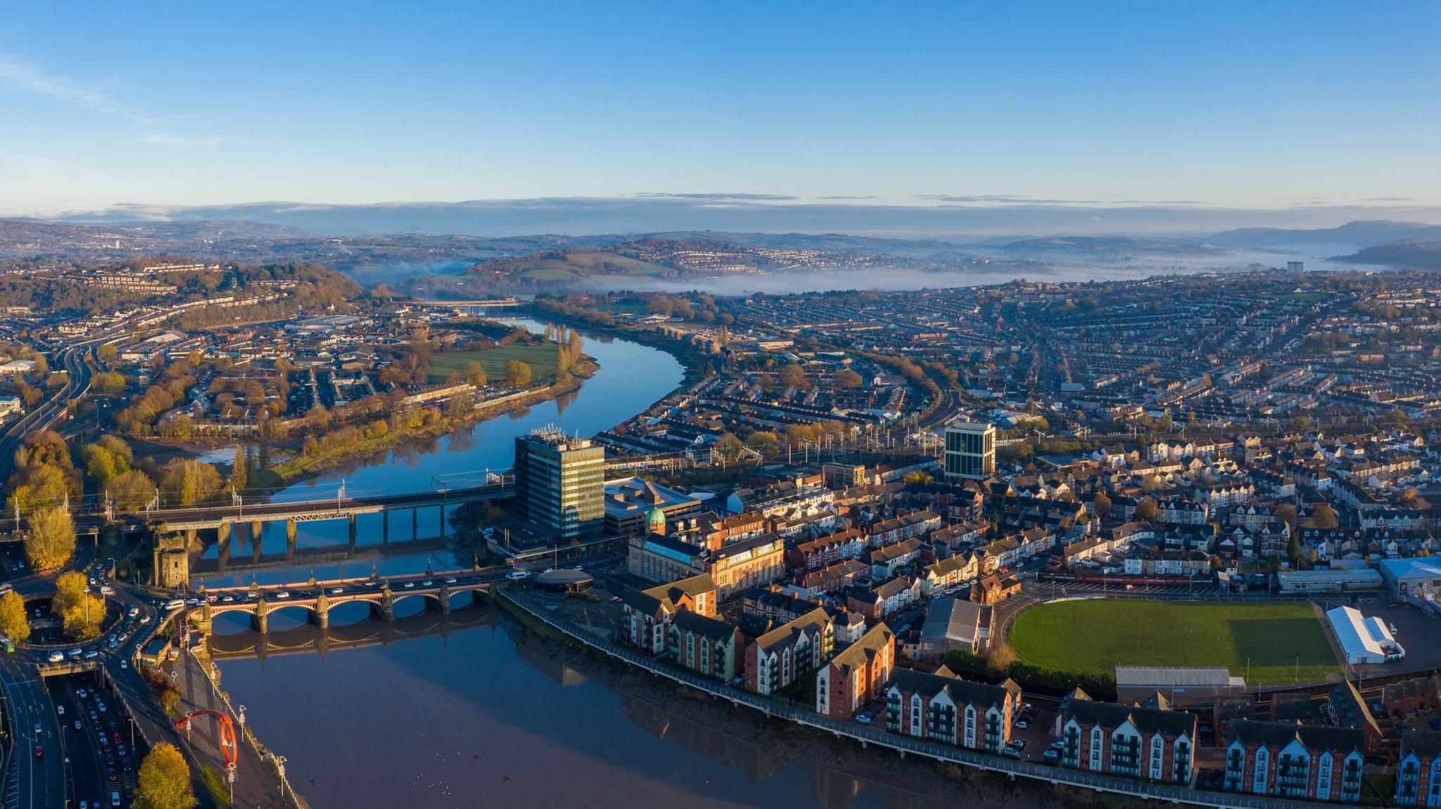 An aerial view at sunrise of Newport city centre, south wales United Kingdom, taken from the River Usk.