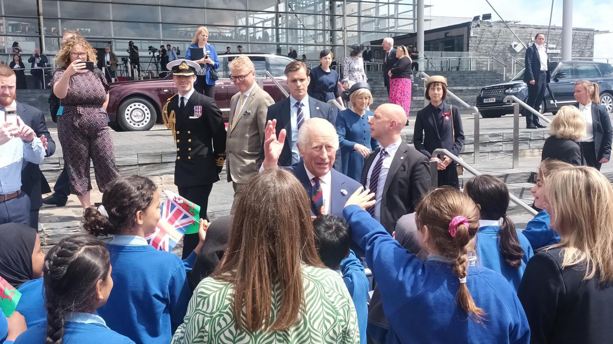 King mingling with crowd of school children