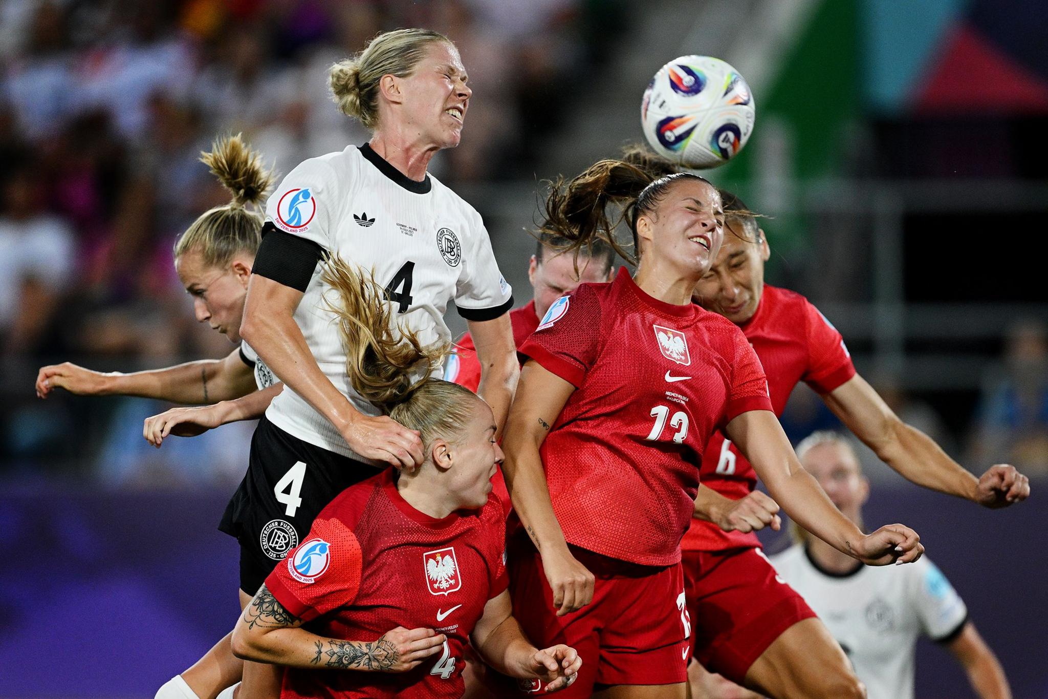Germany's Rebecca Knaak creates a headed chance under pressure from Poland's Paulina Dudek and Emilia Szymczak. Photo by Matthias Hangst