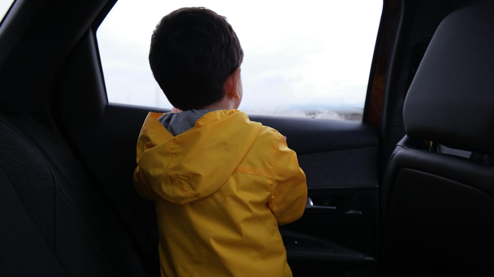 boy looking out of car window. 