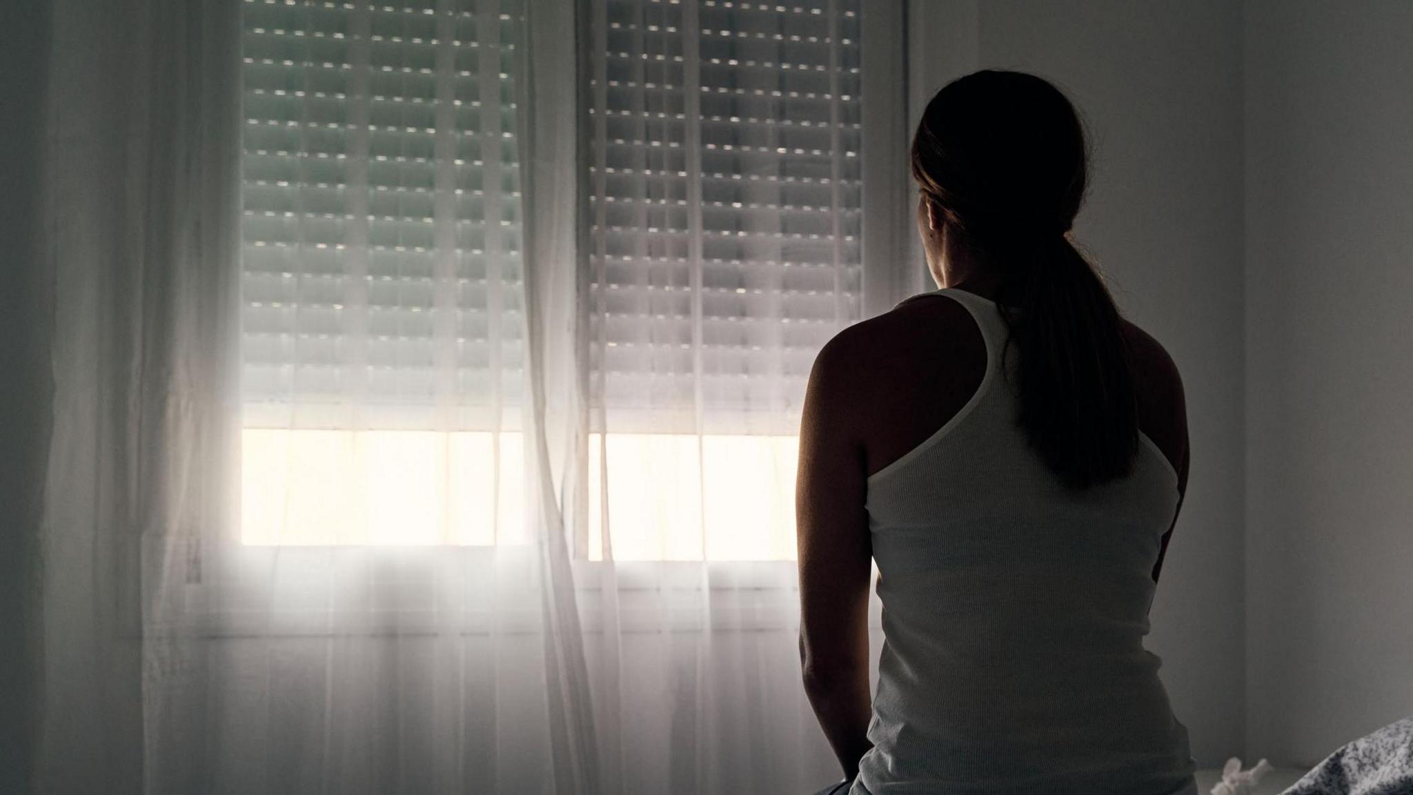 Stock image of woman facing window