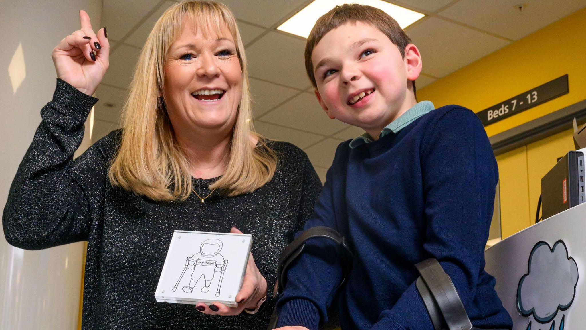 Tony Hudgell and his adopted mother Paula with his commemorative tile