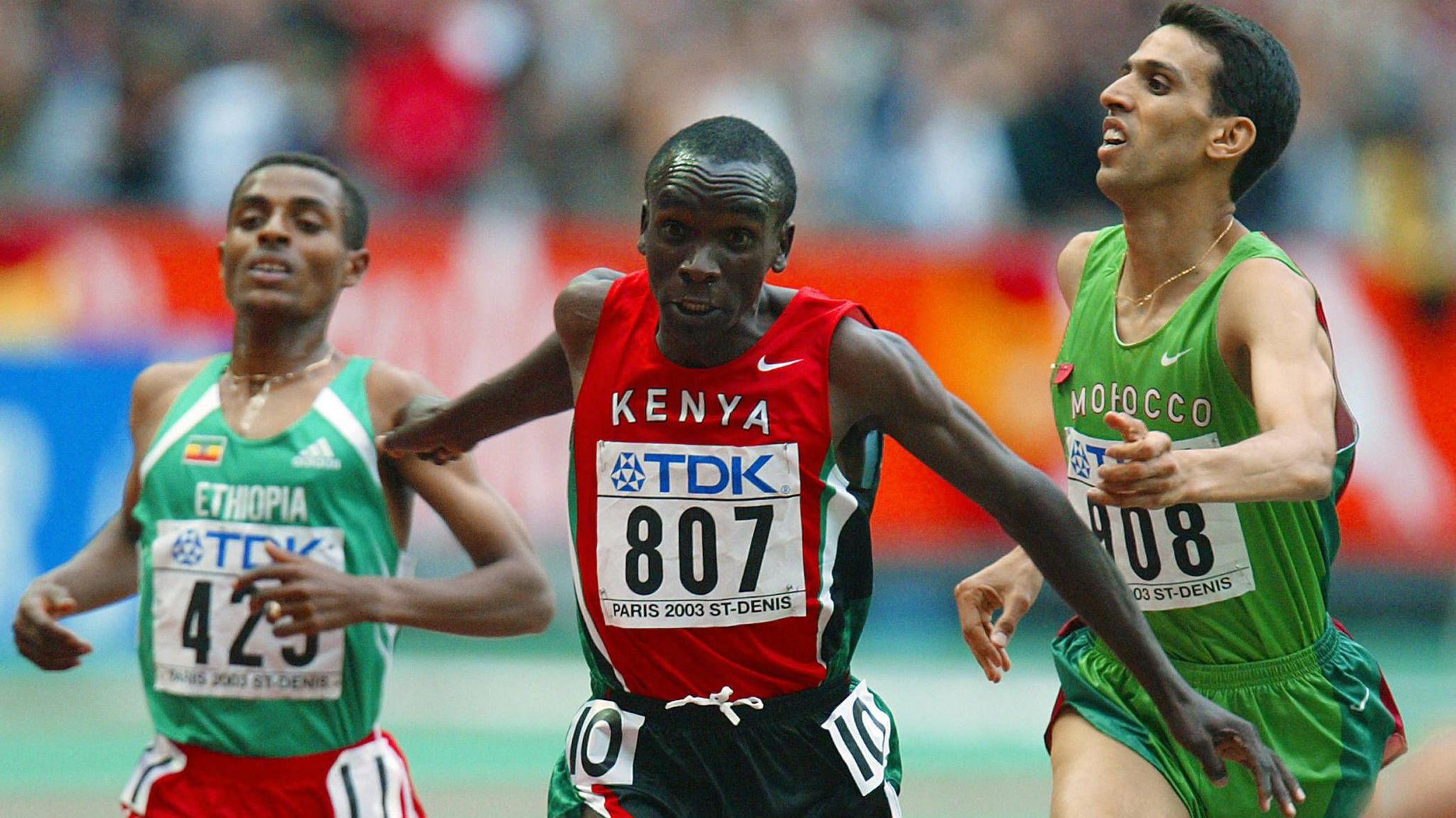 A young Eliud Kipchoge (centre) wearing Kenya running vest dips for the line to beat t major title at the 2003 World Championships in Paris, finish just ahead of Kenenisa Bekele of Ethiopia (left) and Morocco's Hicham El Guerrouj (right)