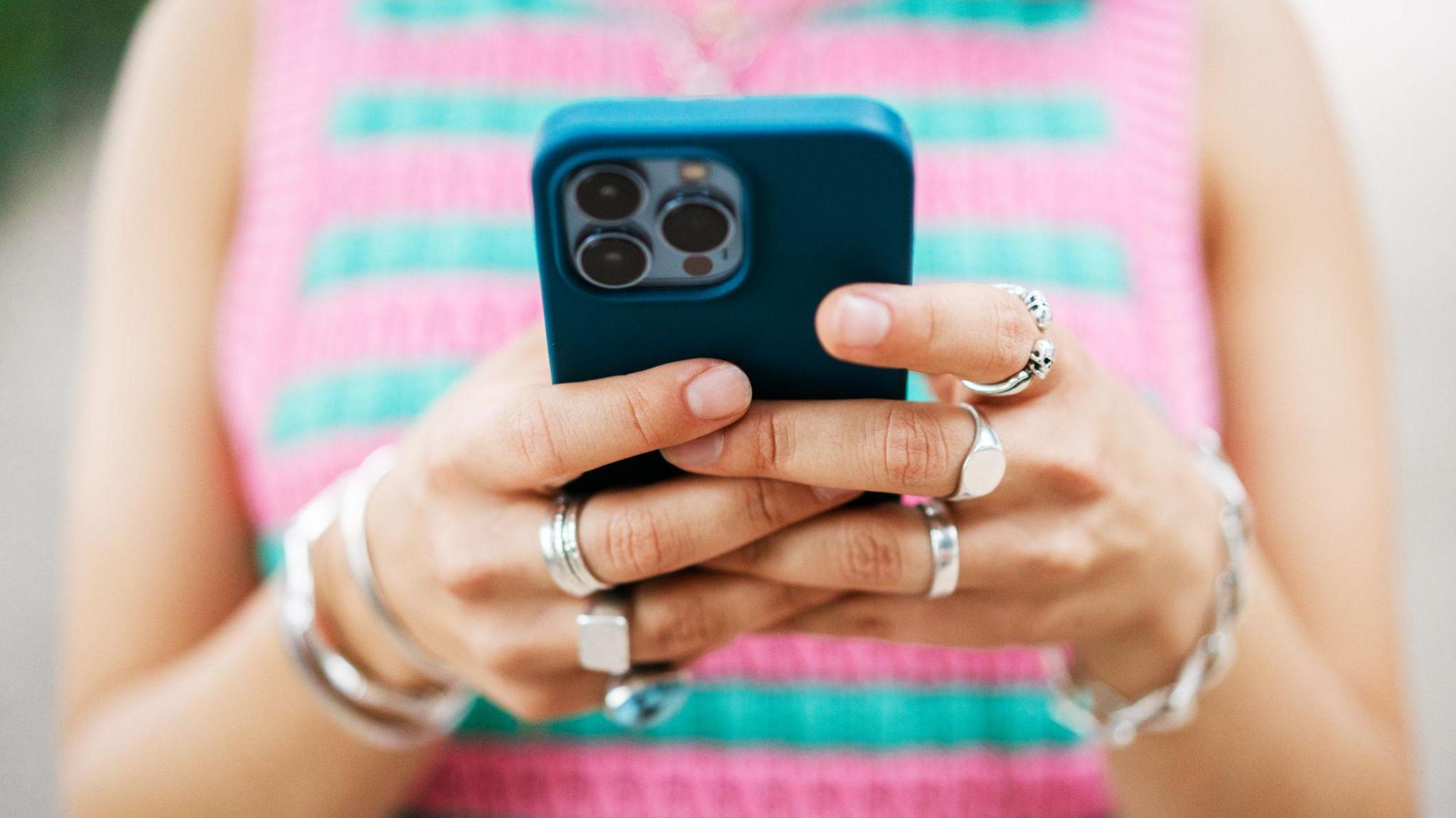 Representative image of a woman using her smartphone