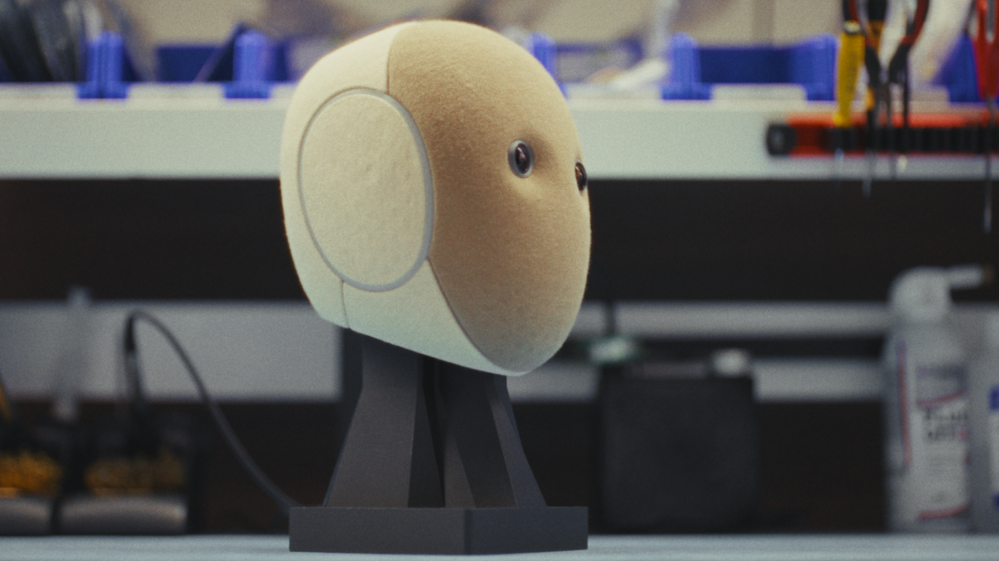 A robots head sits on a workbench