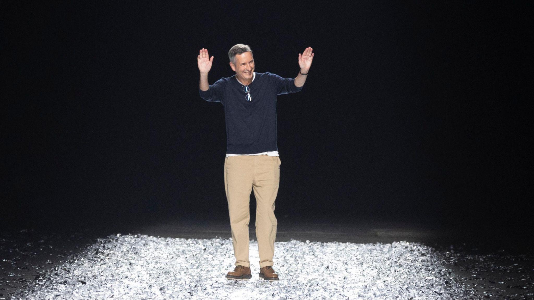 Belgian fashion Designer Dries Van Noten greets the audience at the end of the presentation of his Spring/Summer 2025 Menswear Collection during Paris Fashion Week