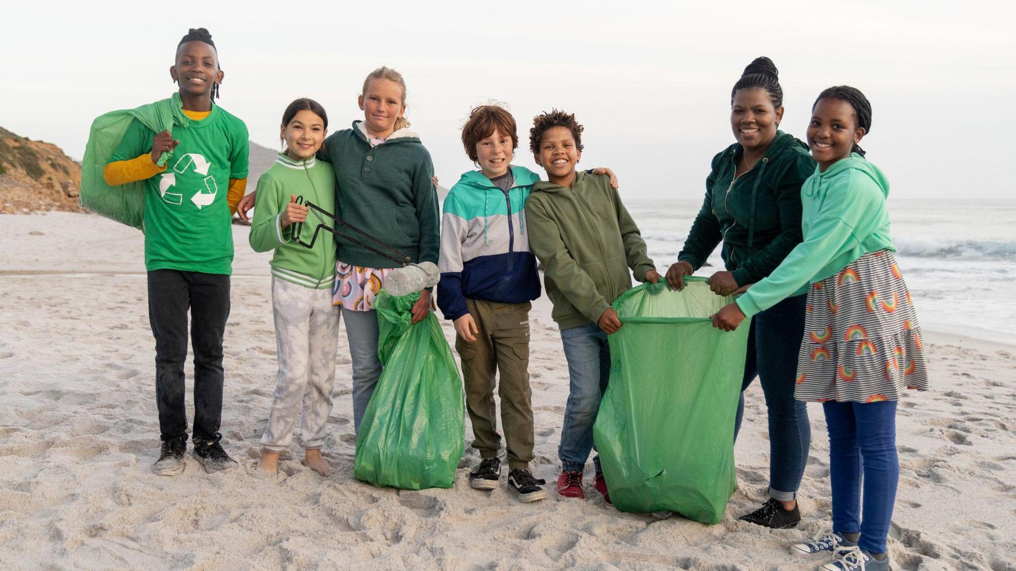 children taking part in a beach clean up