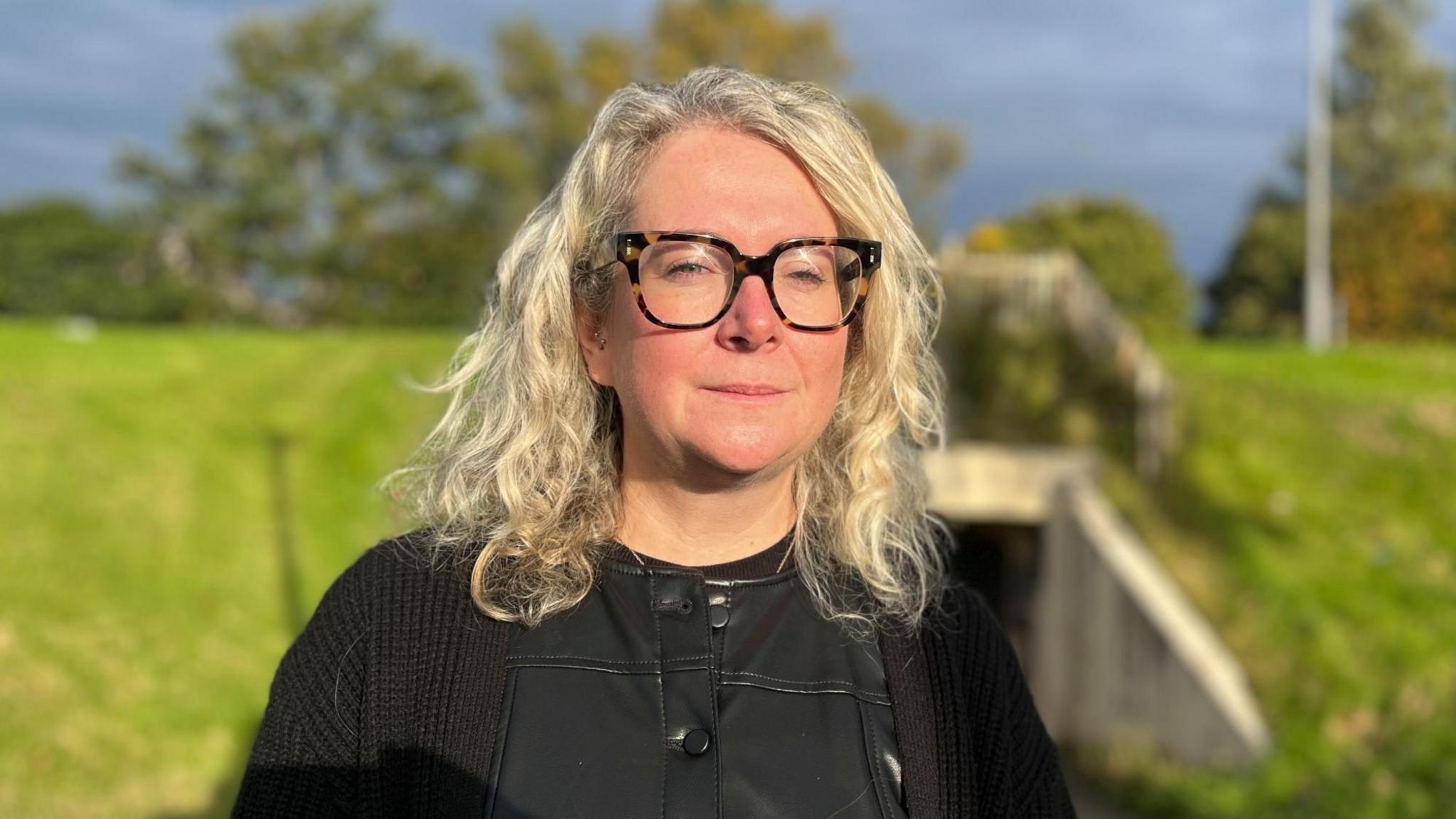 Heather standing outside near an underpass.