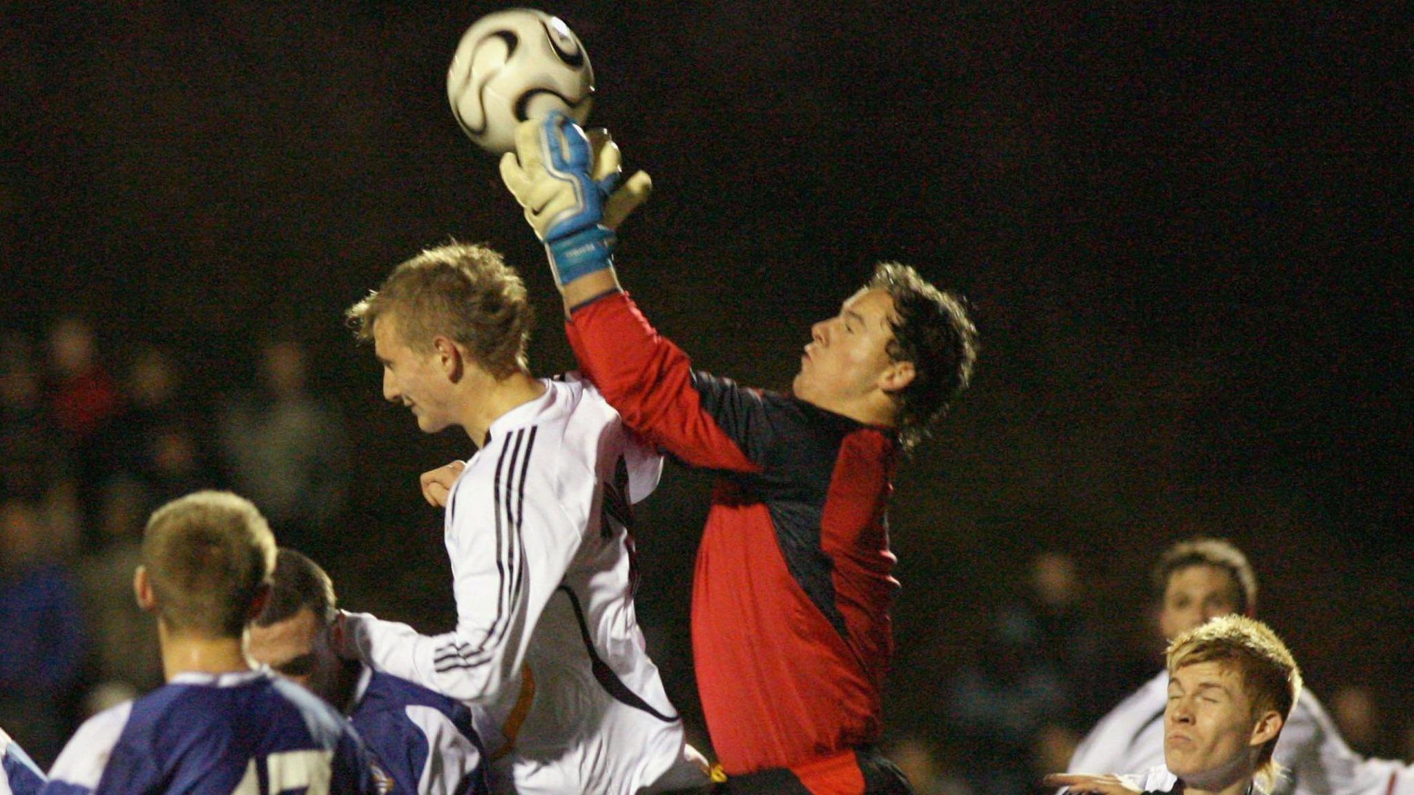  Jonathan Tuffey catching a football while surrounded by German players