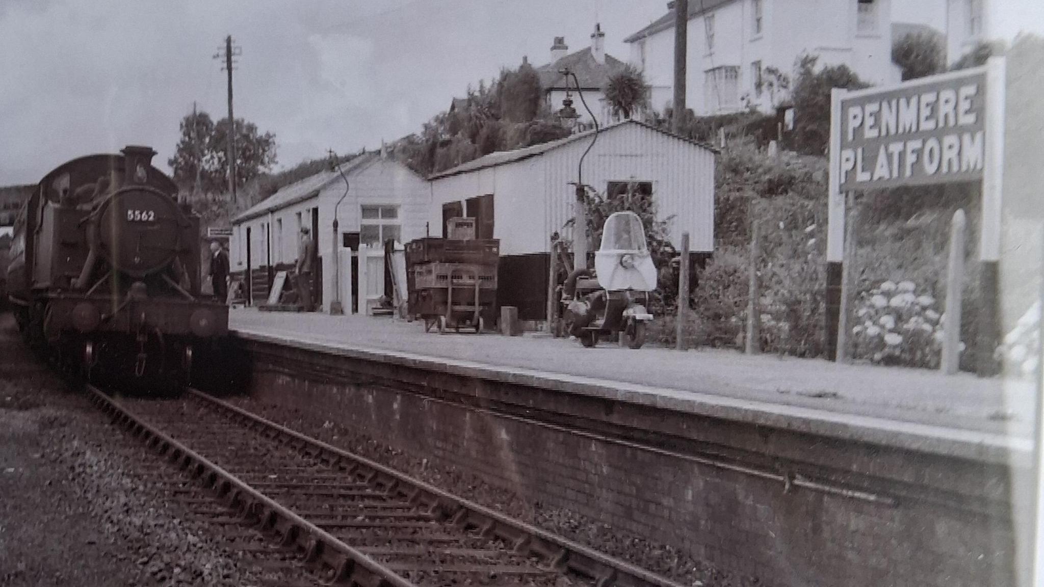 A black and white picture from the 1950s. A steam train pulls into Penmere station 