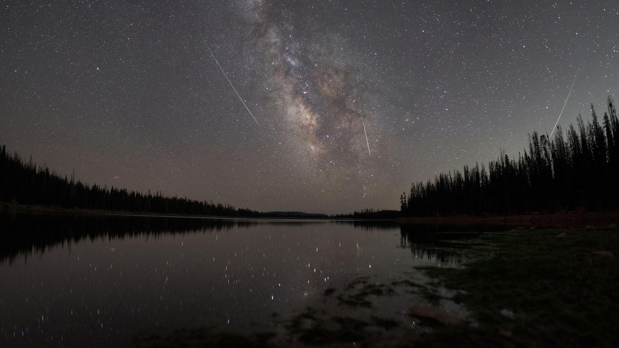 a meteor shower over a lake