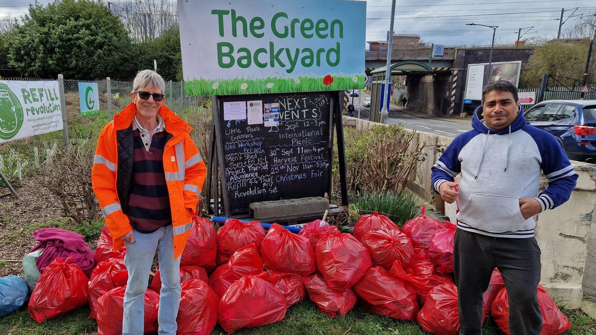 Harry Machin and another volunteer with bags of litter 