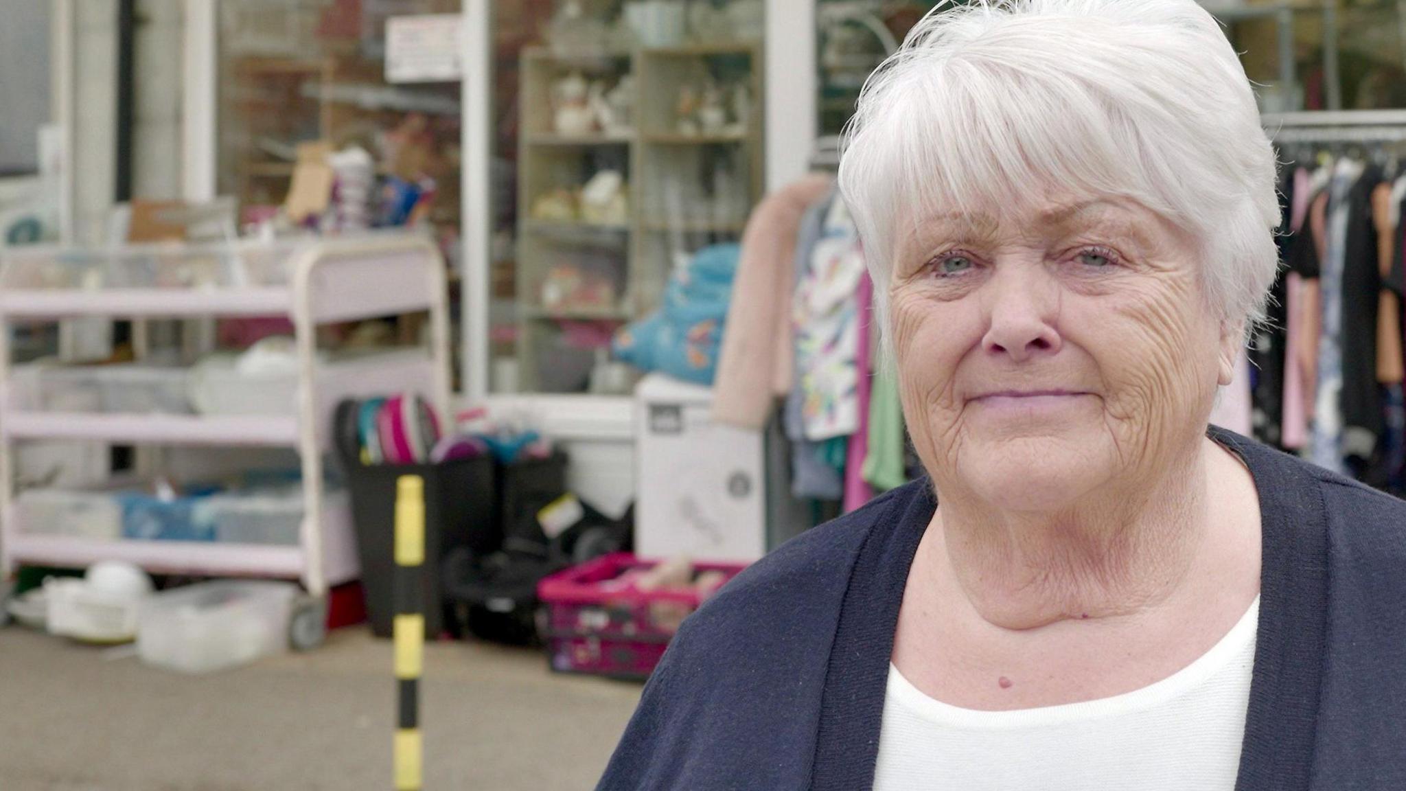 Kath Wilson, founder of a Southport lifeboat charity, standing in front of its shop