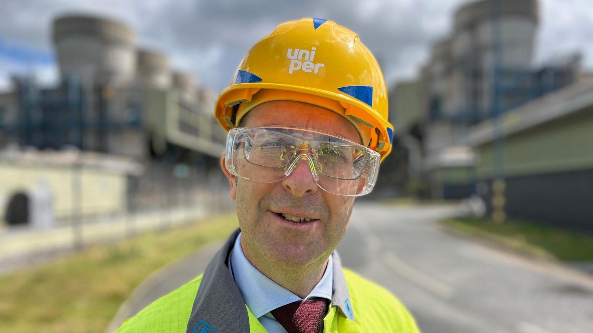 Mike Lockett wearing a neon jacket, protective glasses and an orange hard hat.