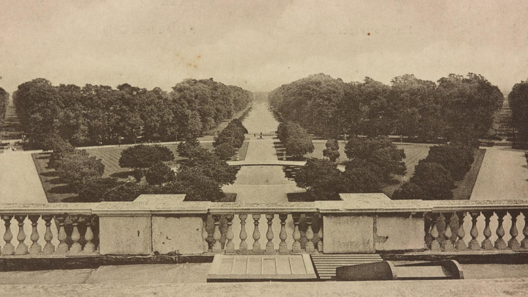 A sepia toned archival image of Hampton Court Palace's garden, showing tree-lined avenues.