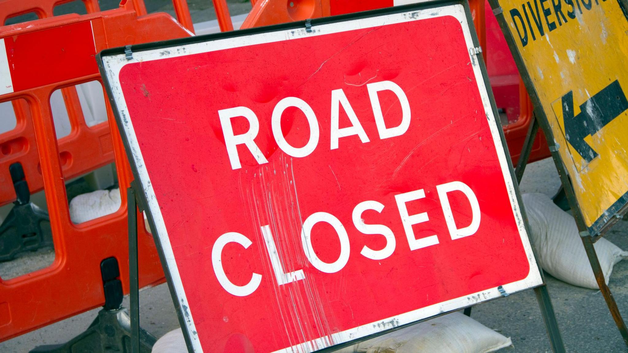 A sign saying 'road closed'.