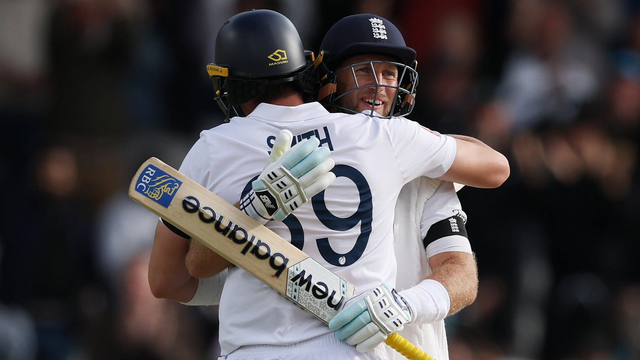 England batters Joe Root and Jamie Smith embrace after beating India