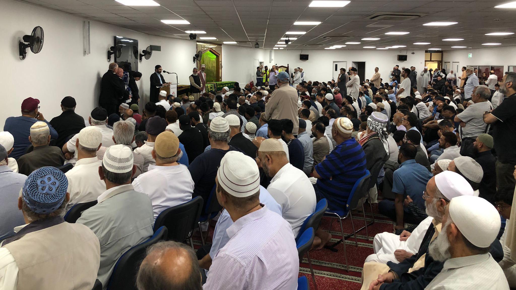 Mourners at funeral service in mosque