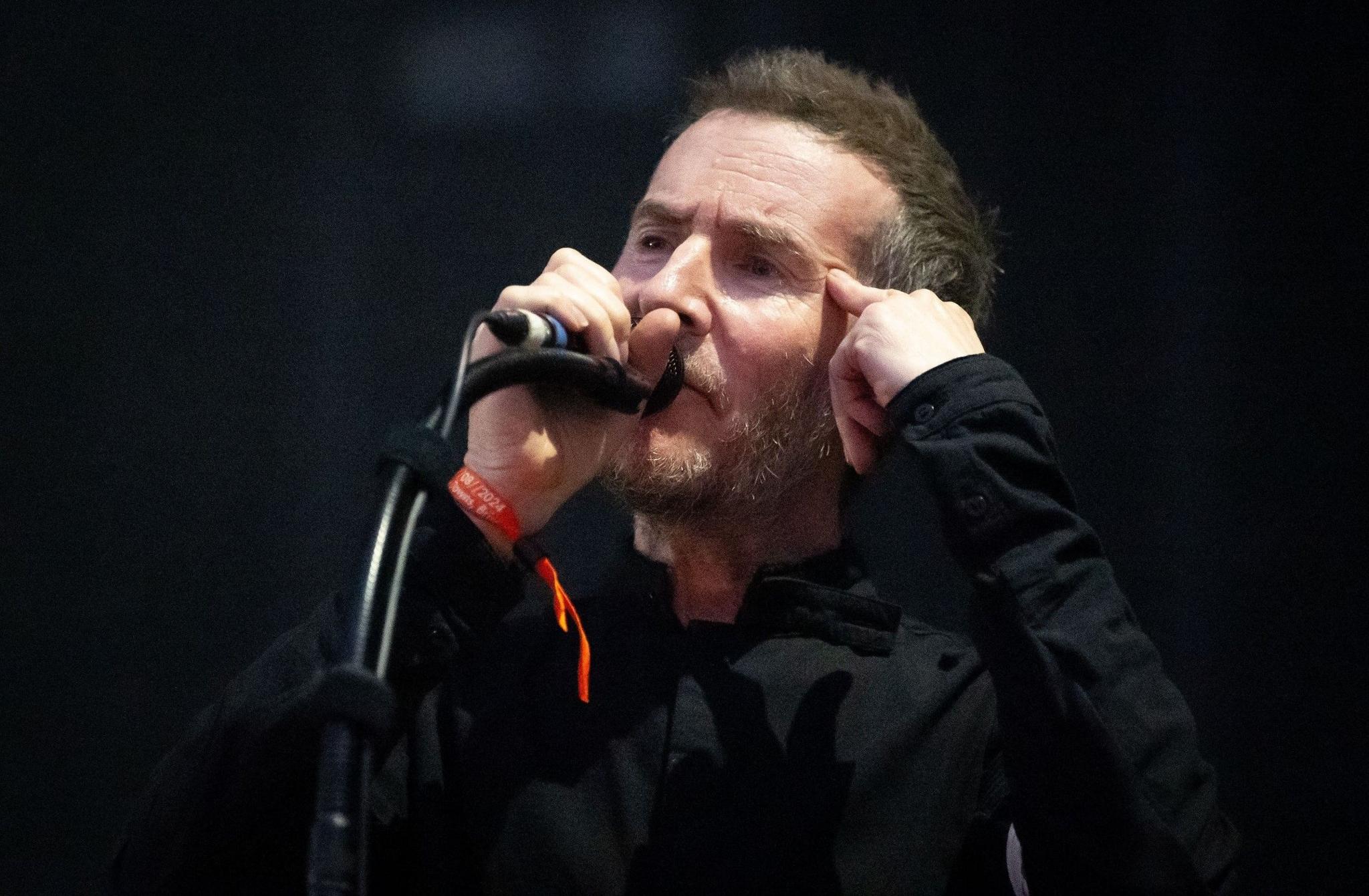 Robert Del Naja from Massive Attack sings on stage during their concert on The Downs in Bristol.