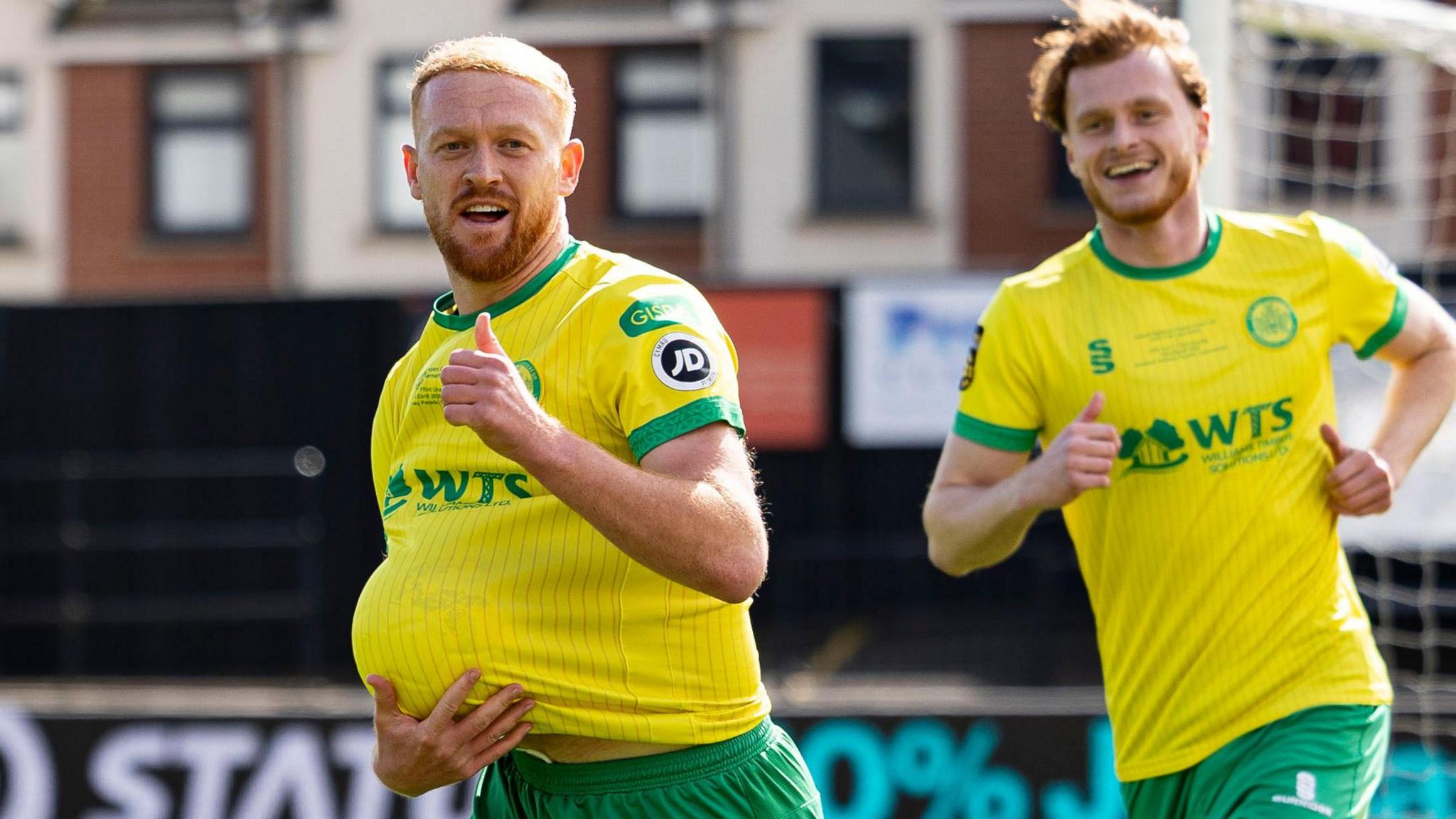 Sion Bradley celebrates after scoring Caernarfon's opening goal against Flint