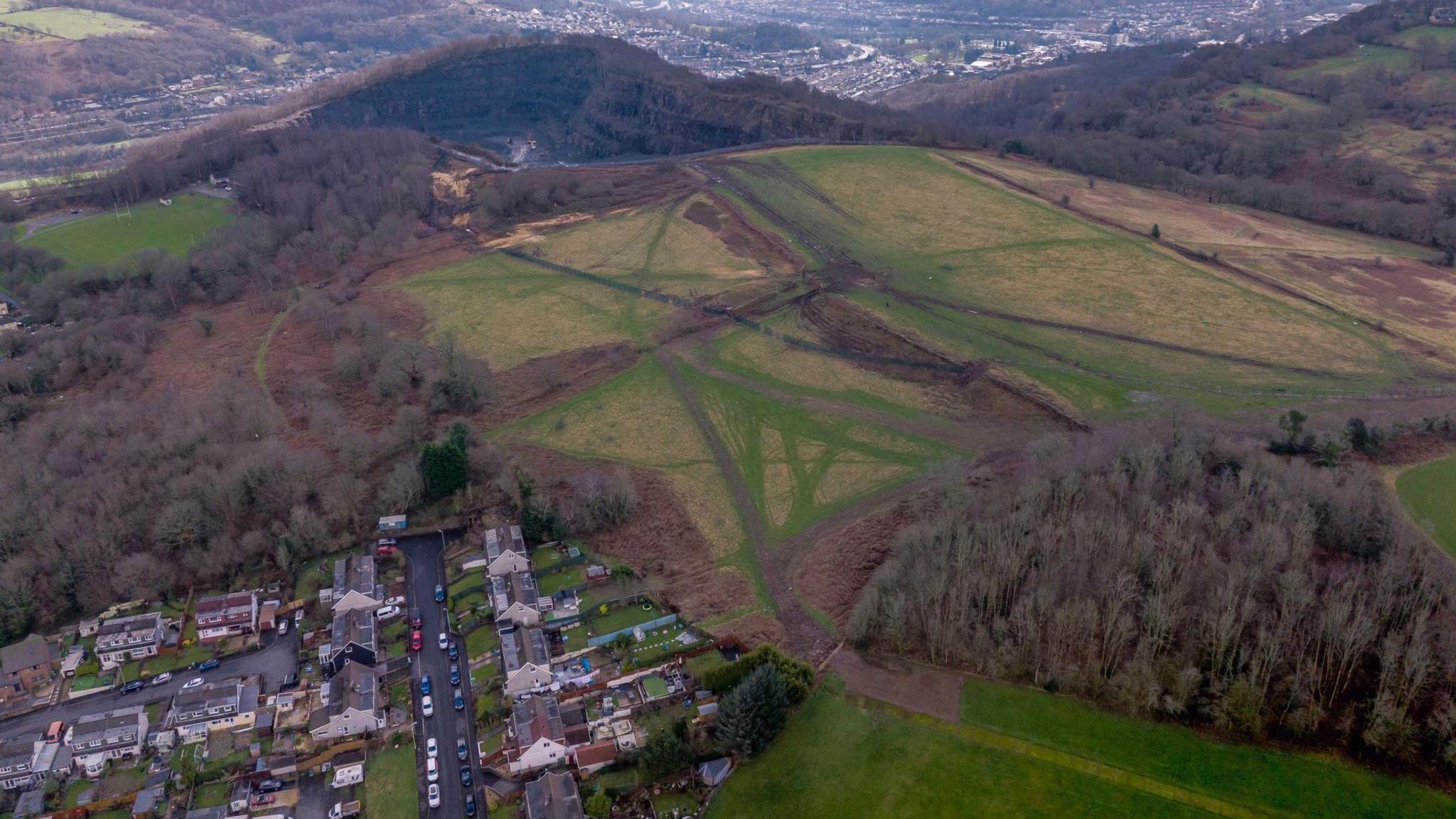 An aerial image of the quarry with houses in the foreground