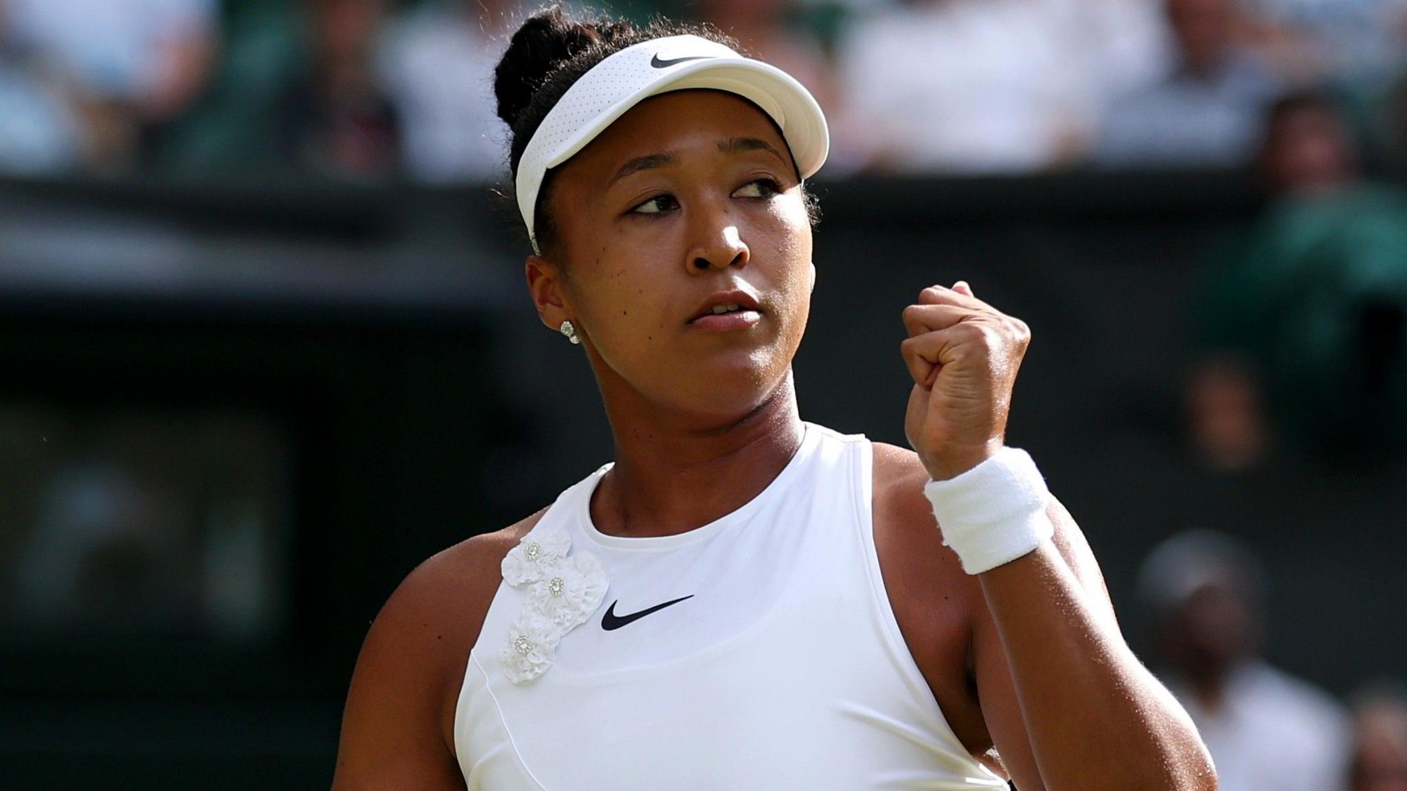 Naomi Osaka clenches her fist in celebration after beating Aryna Sabalenka