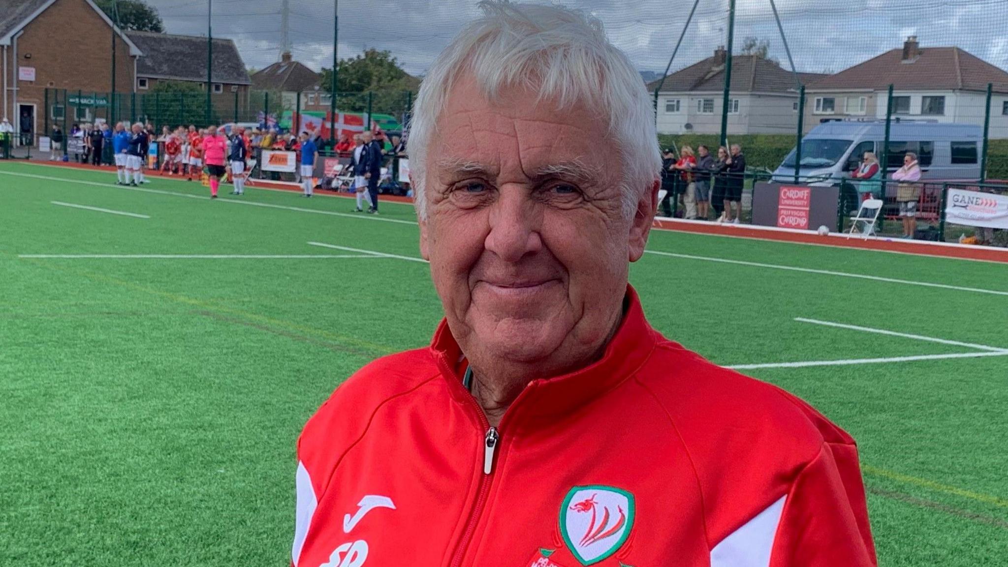 Steve Davies standing pitchside in his Wales tracksuit 