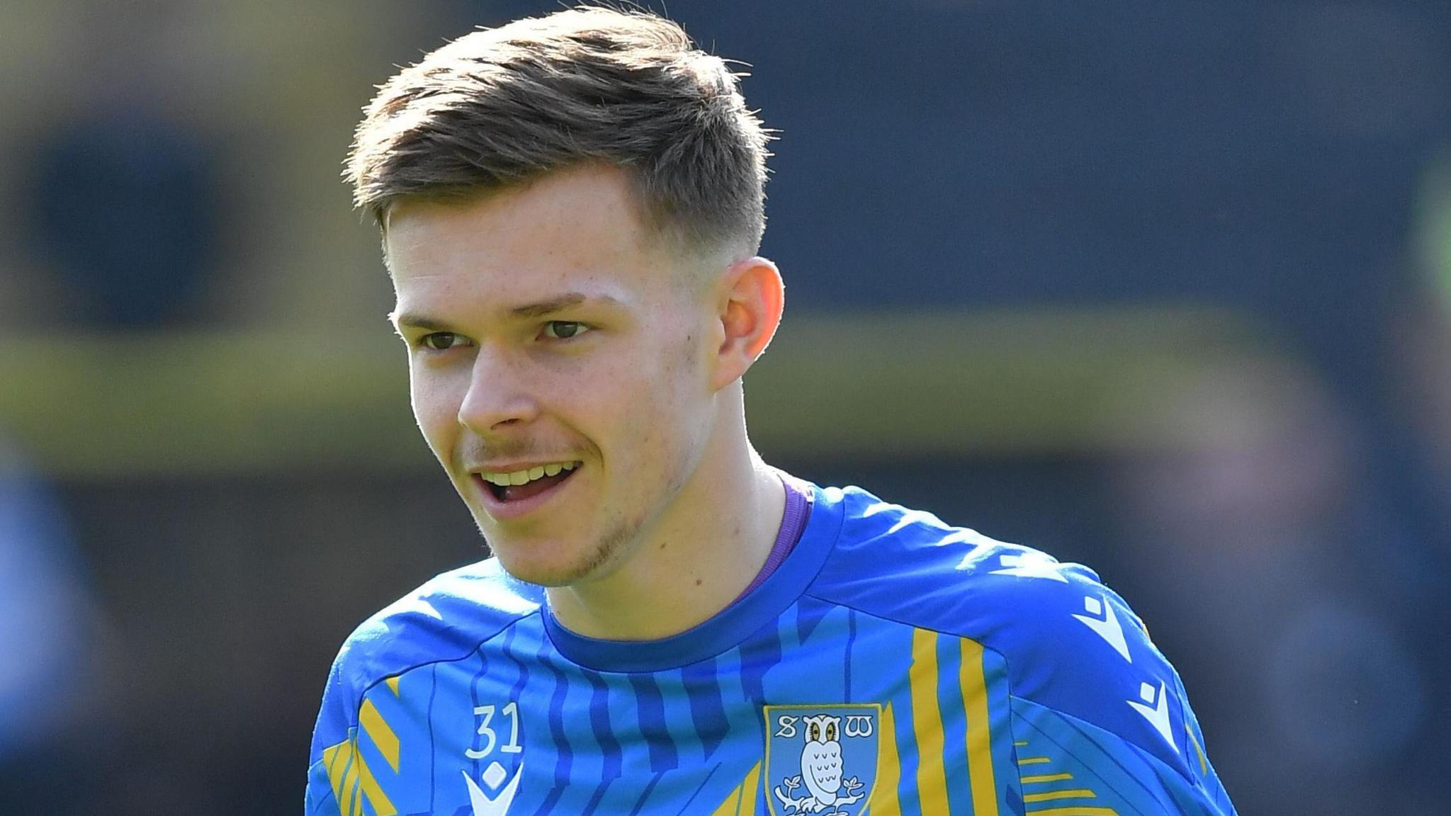 Will Grainger wearing a blue Sheffield Wednesday training top before a Championship game against Hull City in March 2026