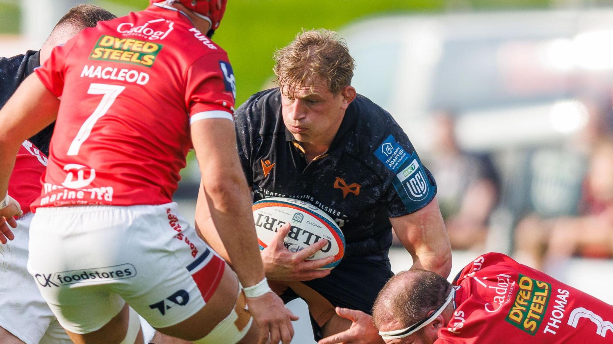 Jac Morgan carries the ball for Ospreys against Scarlets