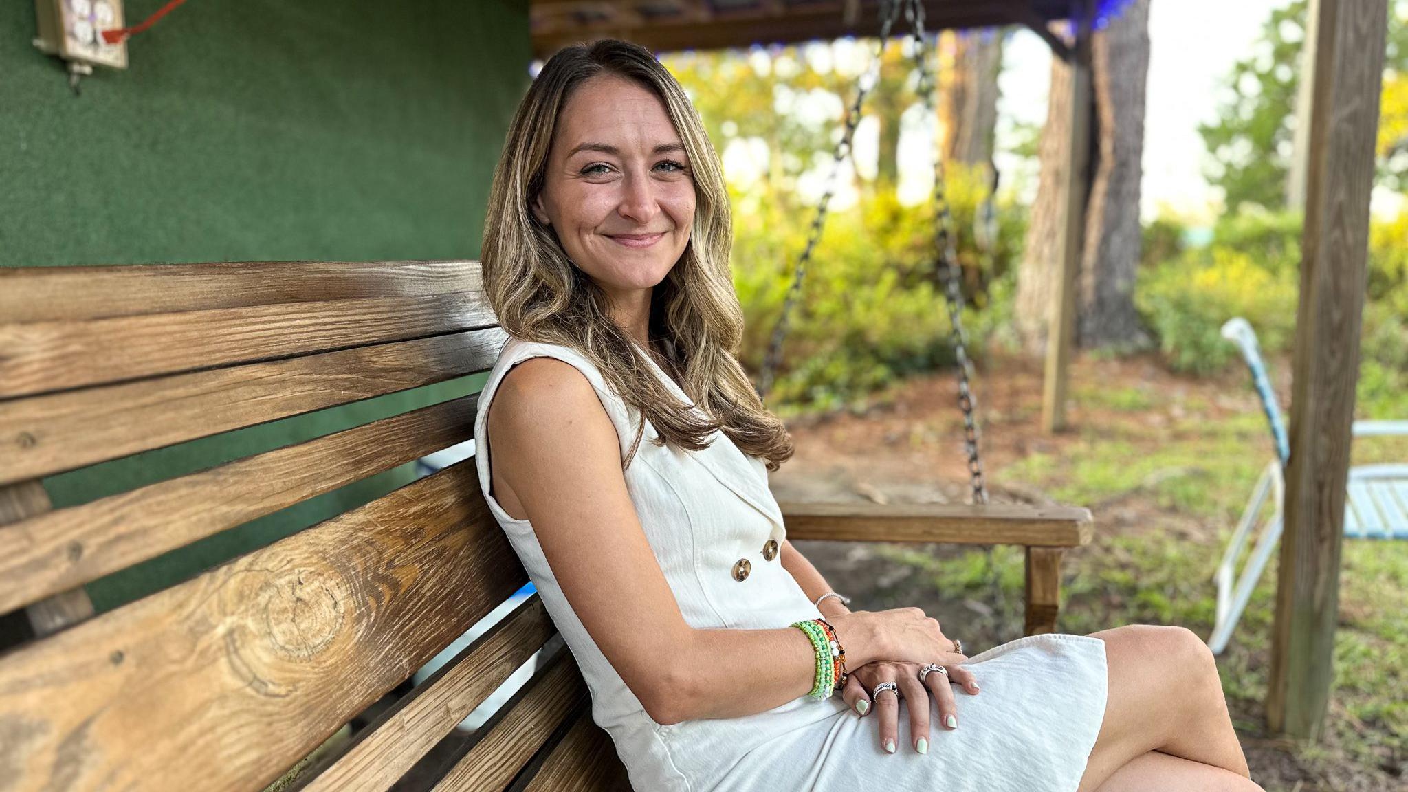 Anderson Clayton sits on a hanging bench 