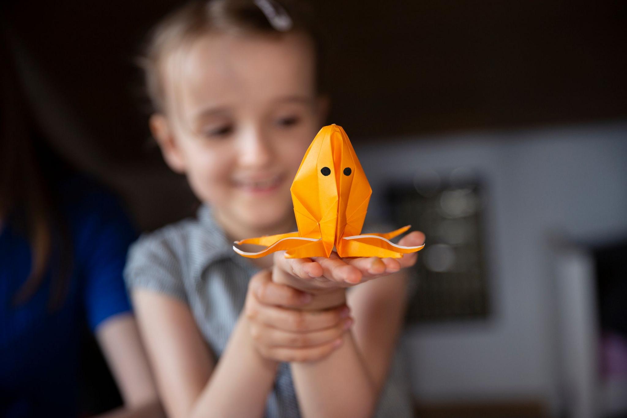 girl holding an origami octopus. 