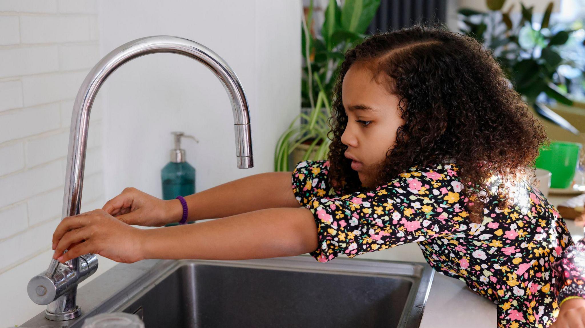 Girl turning off taps