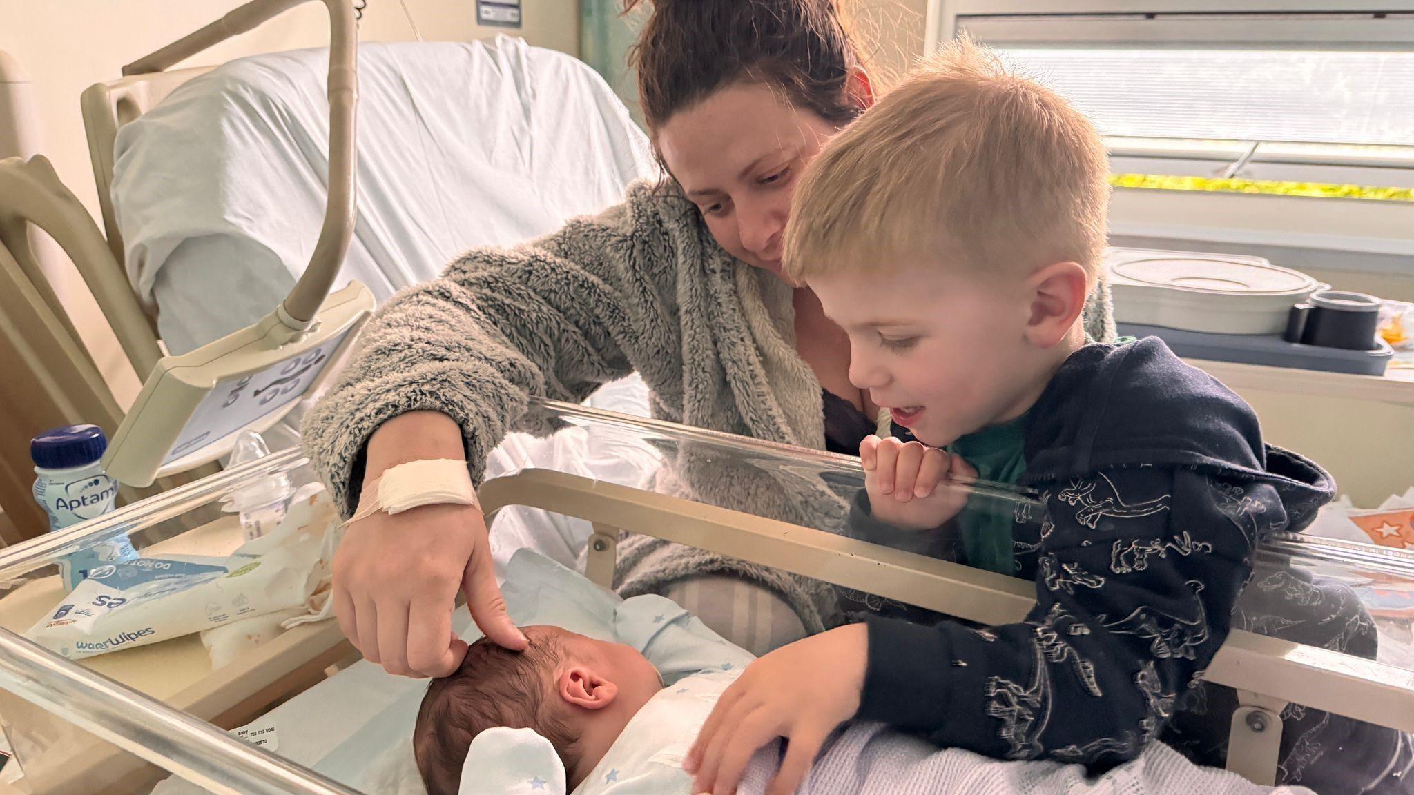 Sophie in hospital with a new born child and her other son