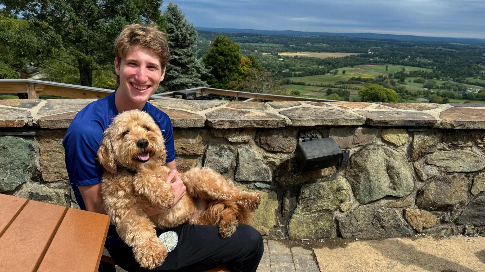 Brendan Papp with his dog Bowie, smiling at the camera