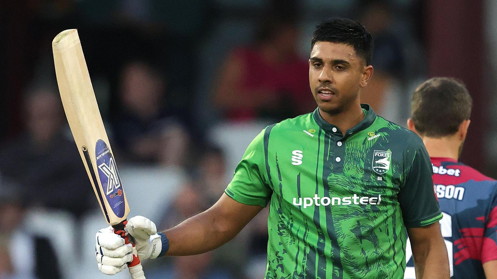 Rishi Patel lifts his bat after scoring a century against Northamptonshire in the T20 Blast