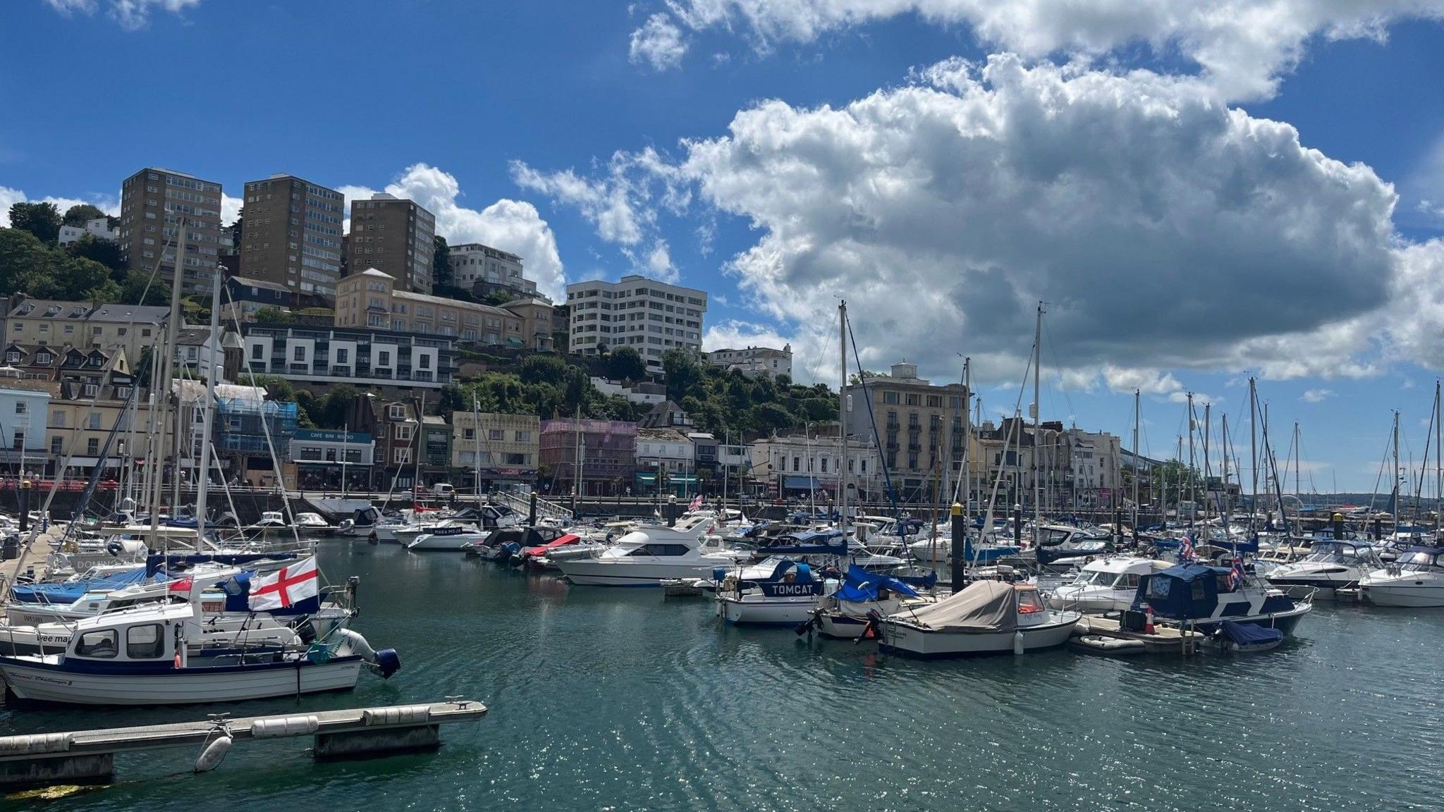 The inner harbour in Torquay and blocks of flats on the hillside