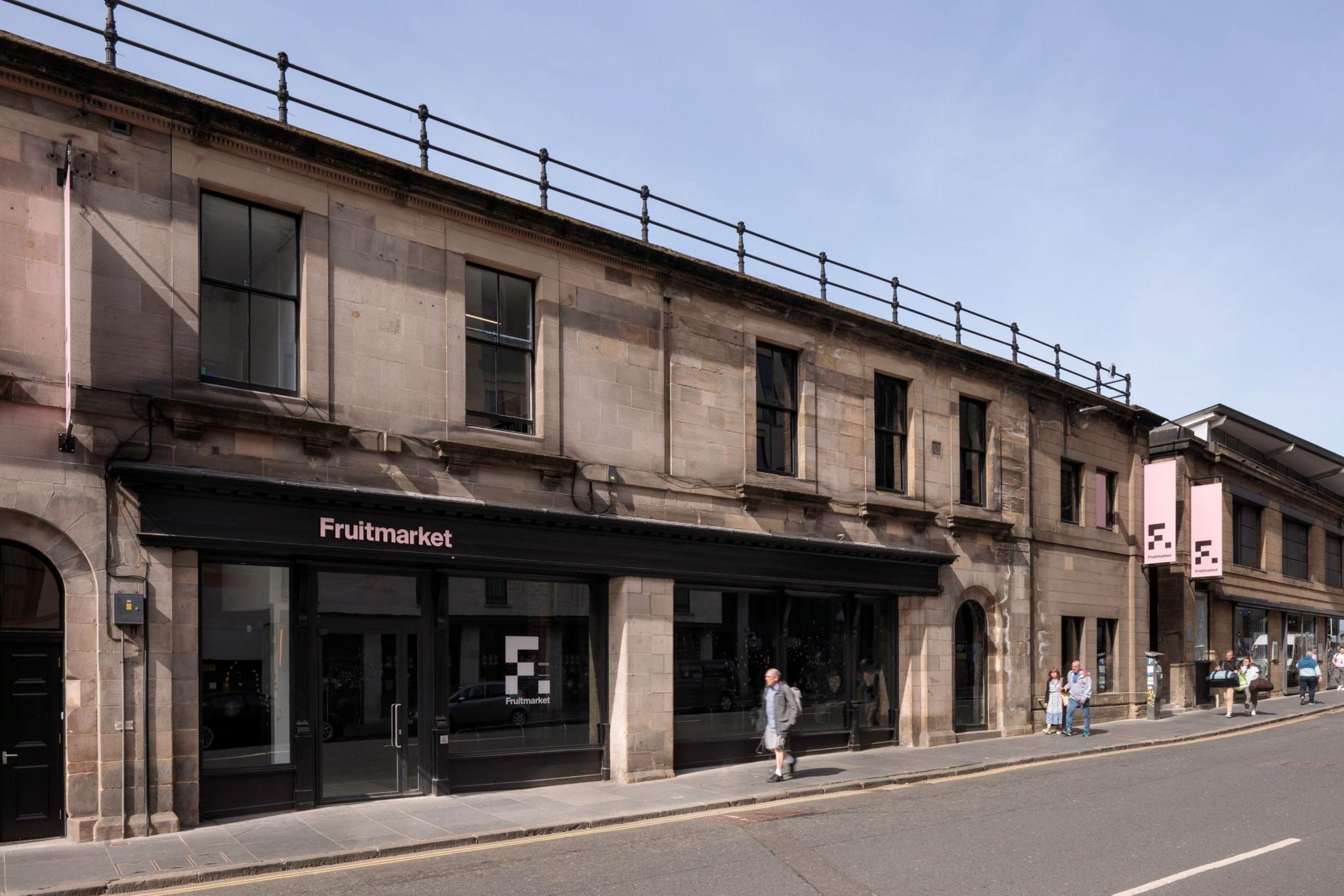 The exterior of the Fruitmarket gallery in Edinburgh - a two-storey building with a black sign