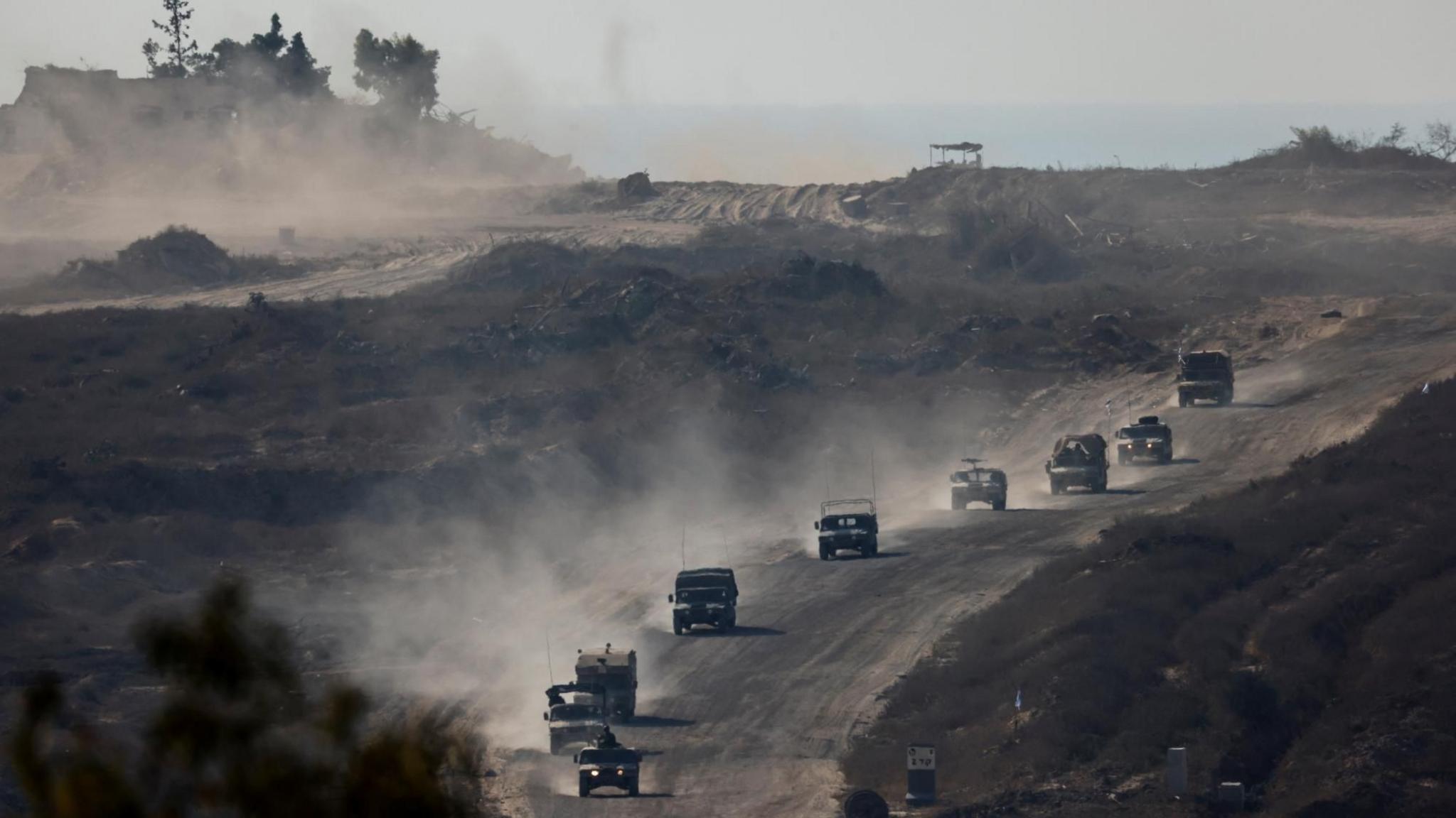 Israeli military vehicles inside the Gaza Strip, as seen from Israel (14 August 2024)