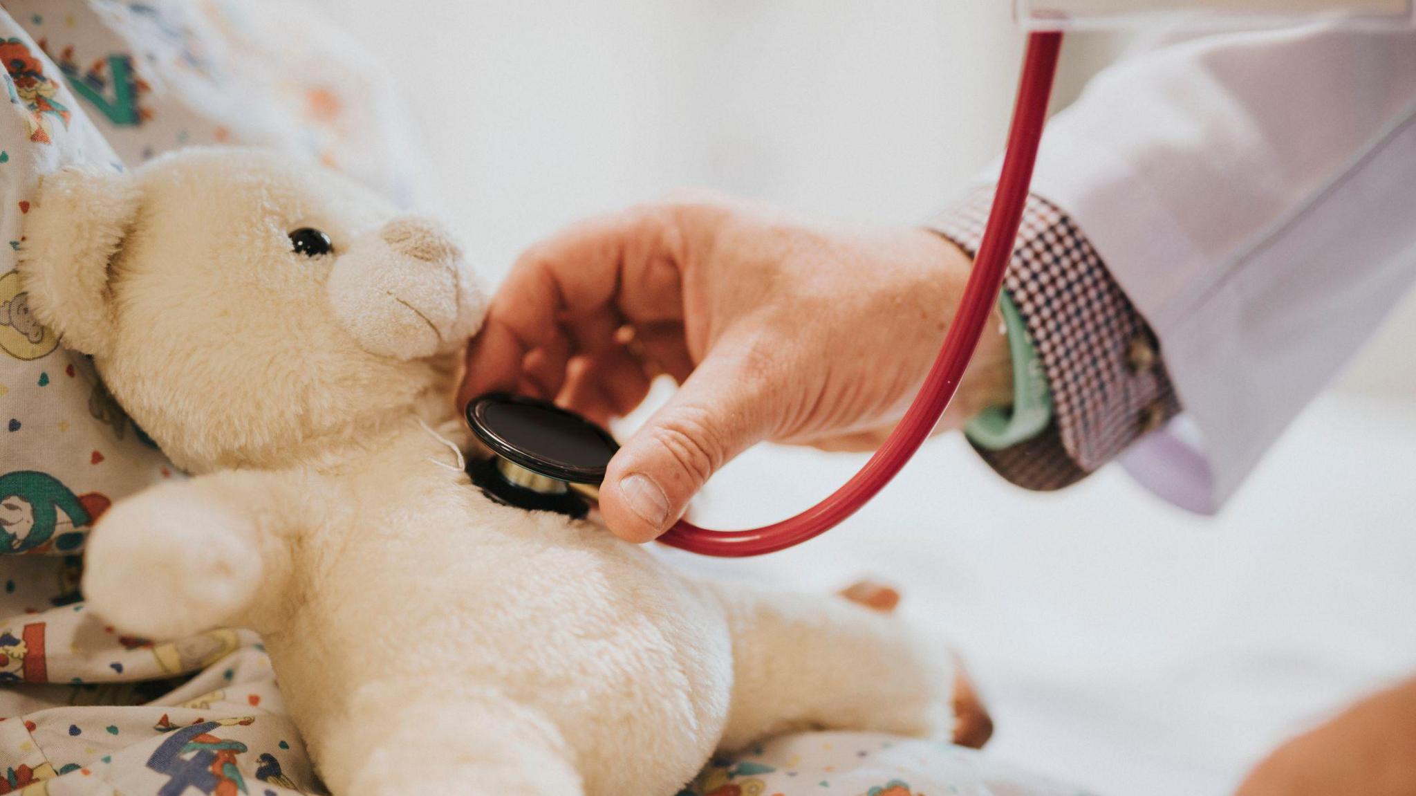 Doctor taking teddy heart beat 