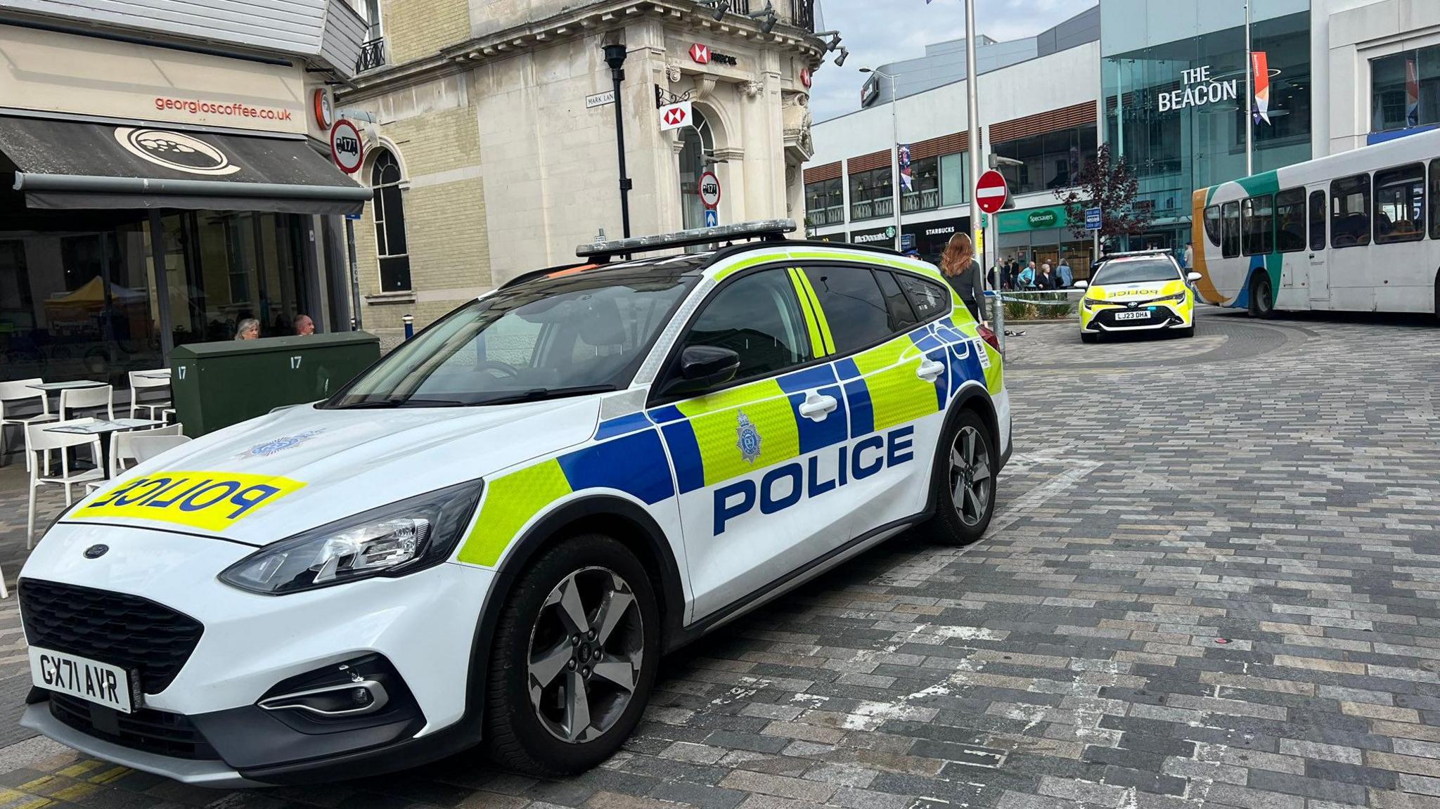 Two police cars parks outside an HSBC bank