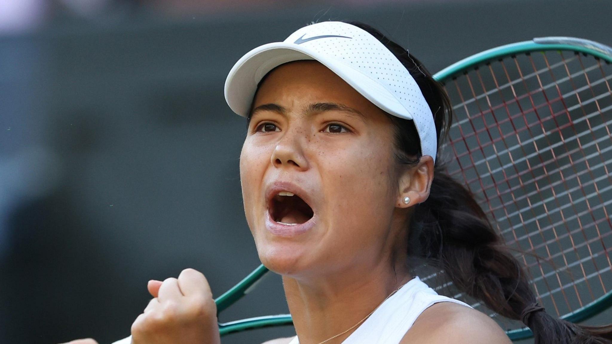 Emma Raducanu clenches her fist in celebration at Wimbledon